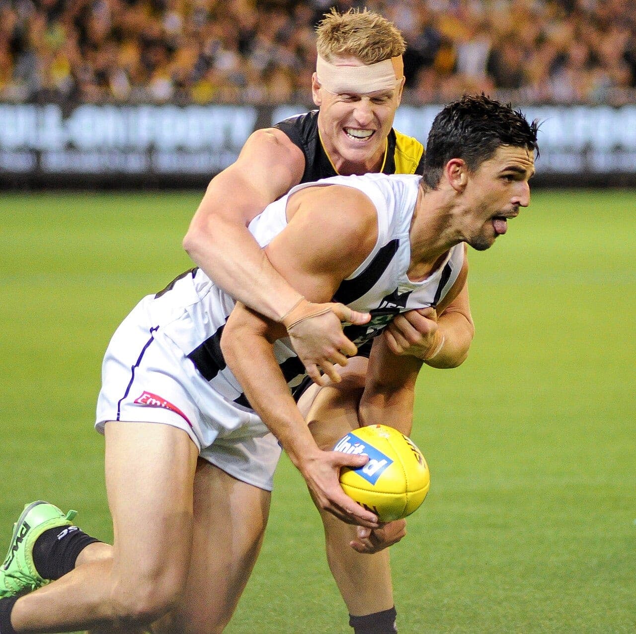 Richmond's Josh Caddy tackles Collingwood's Scott Pendlebury during a match at the MCG in 2017 (file photo).