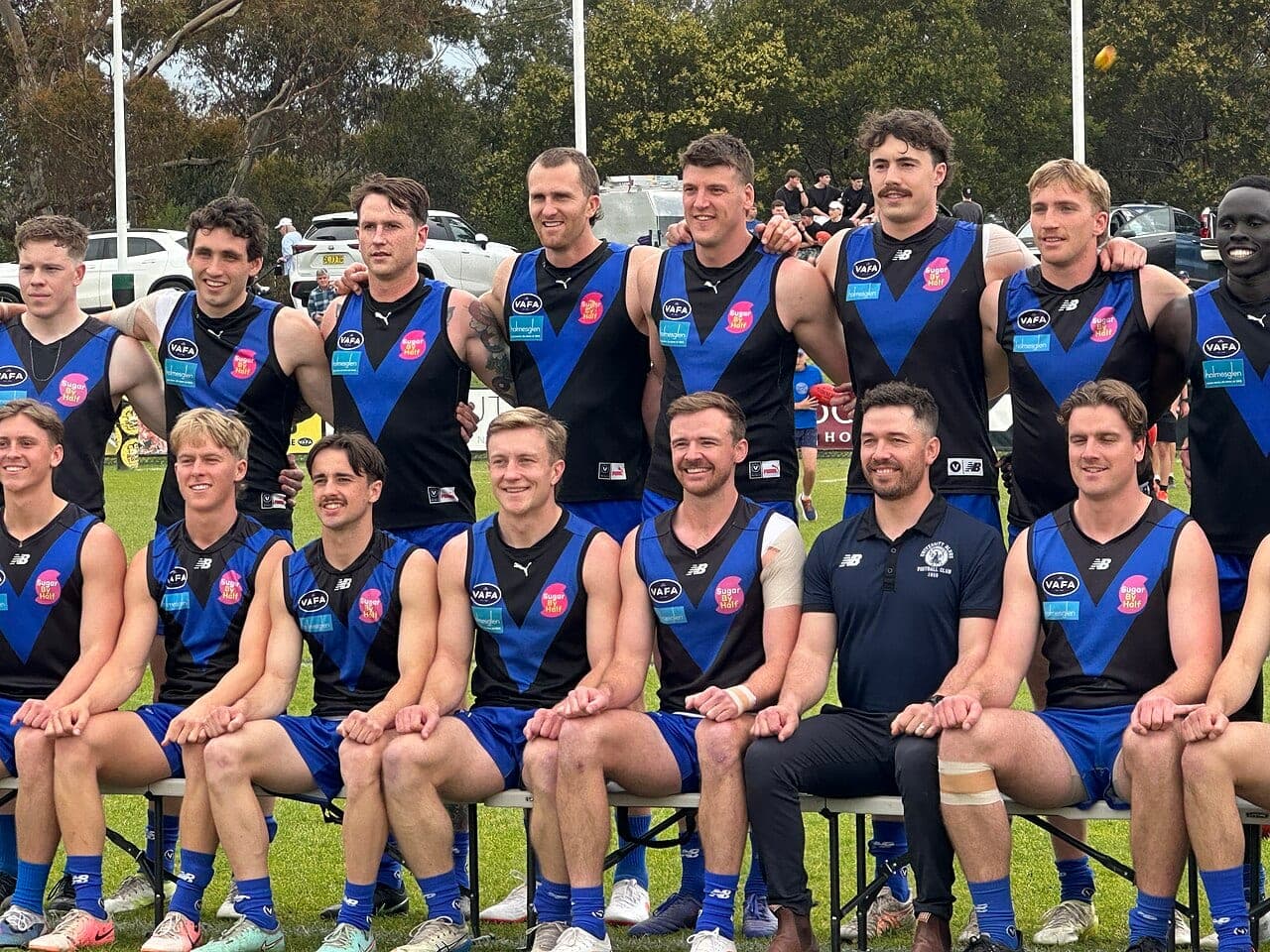 University Blues players pose for a team photo before the 2026 VAFA Premier Men's Grand Final against Old Xaverians at Revo Fitness Park.
